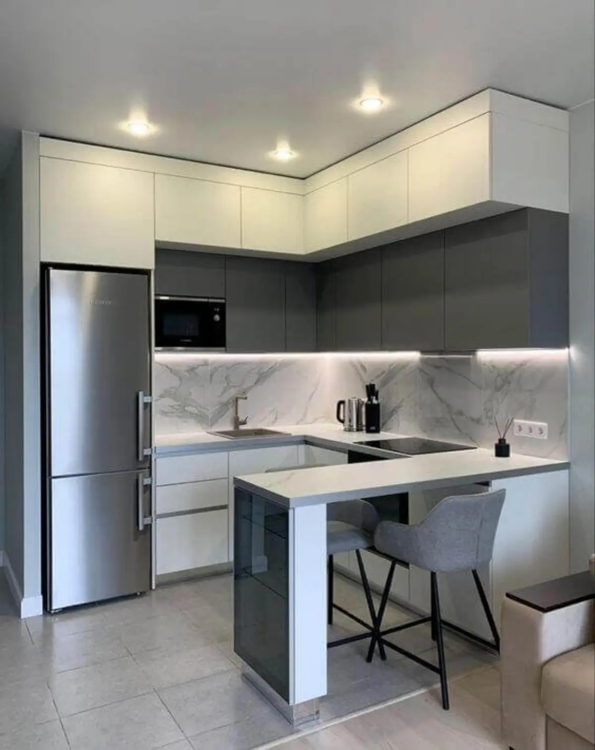 کابینت مدرن سفید طوسی با نورپردازی خطی همراه با کانتر سفید